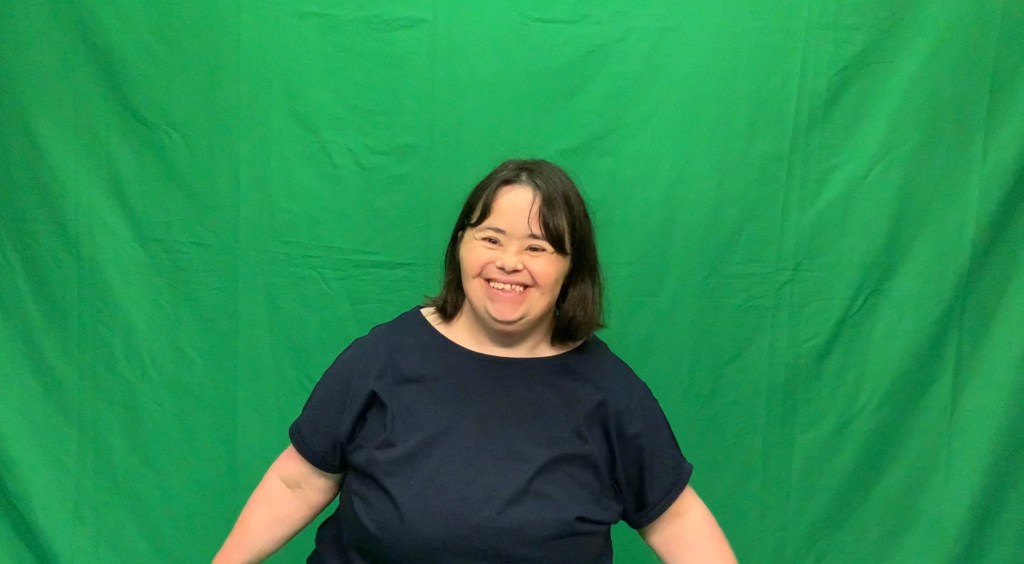 Debbie in front of the green screen
