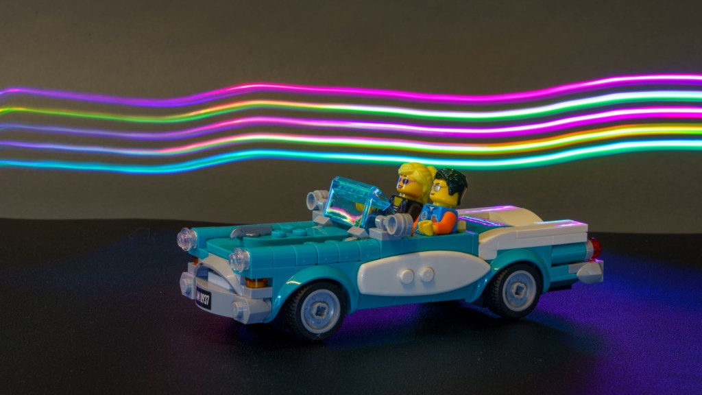 Light painting photo of a Lego car and mini figures