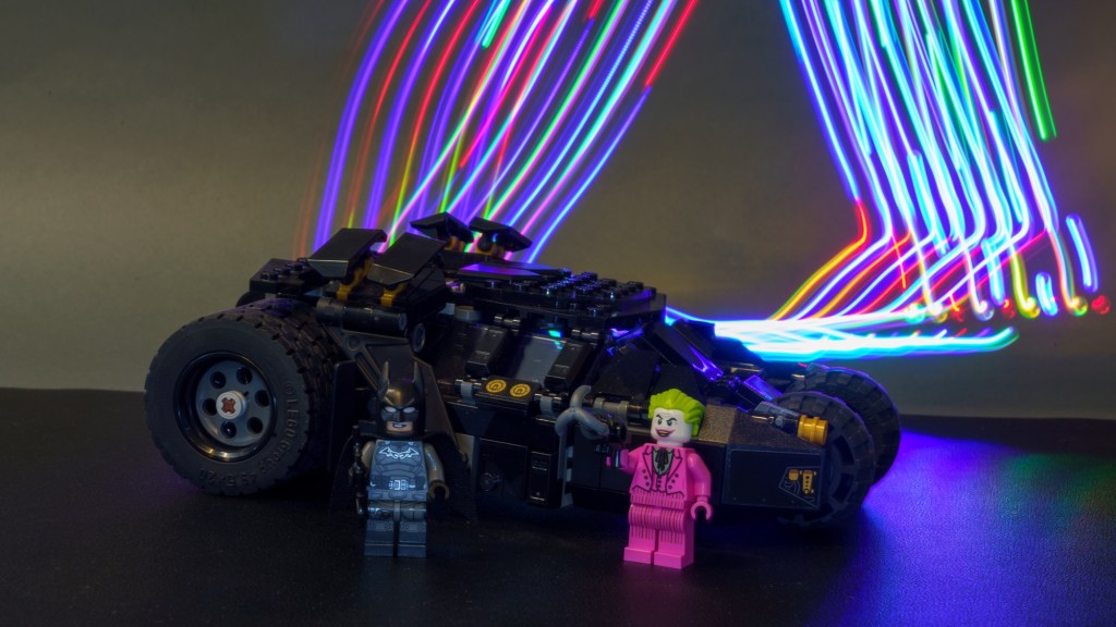 Light painting photo of a Lego Bat mobile and Batman mini figures