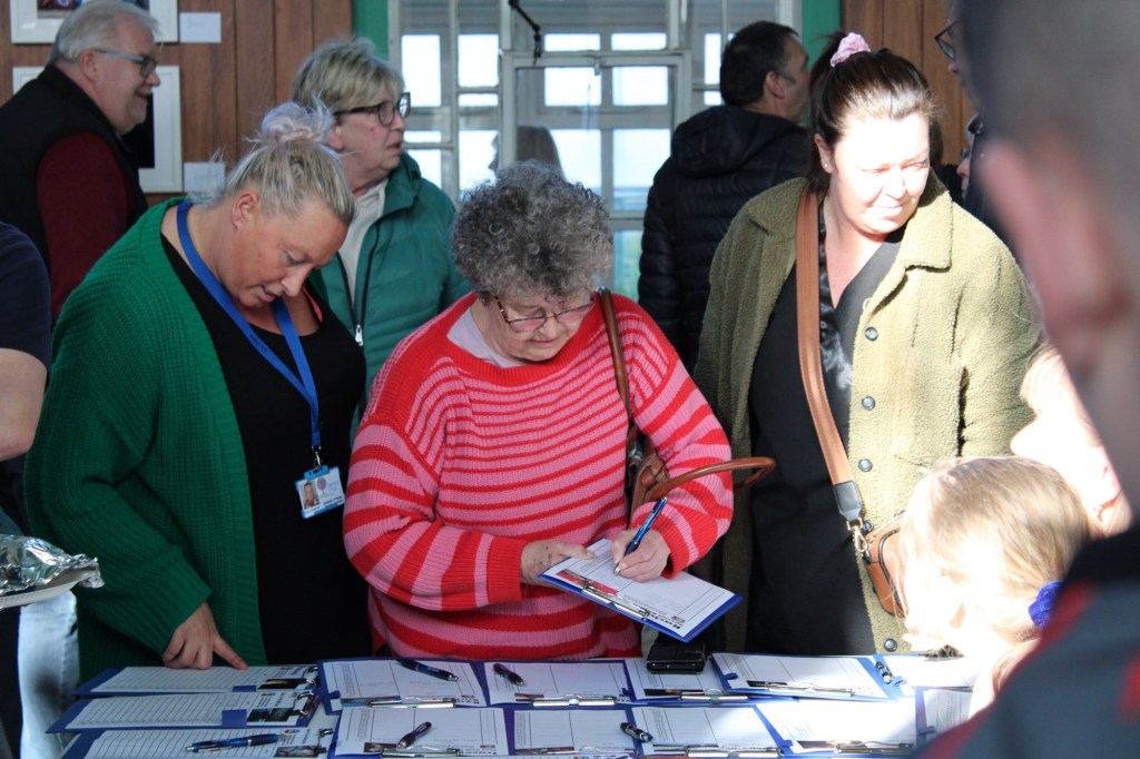People bidding on LEGO portraits at the 2024 exhibition 