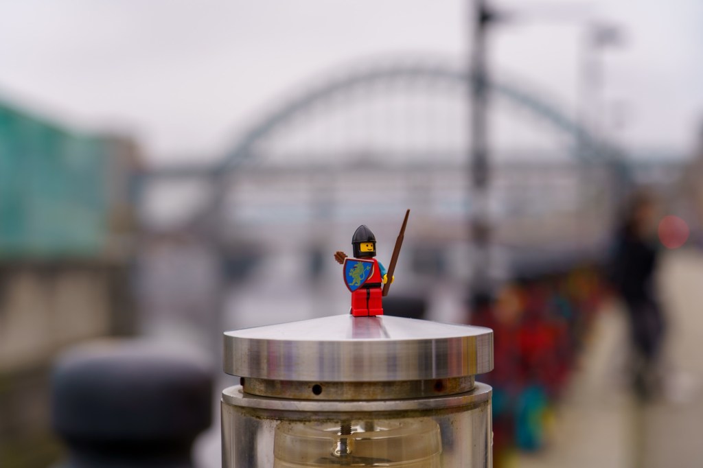 Mediaeval knight Lego figure in front of the Tyne Bridge