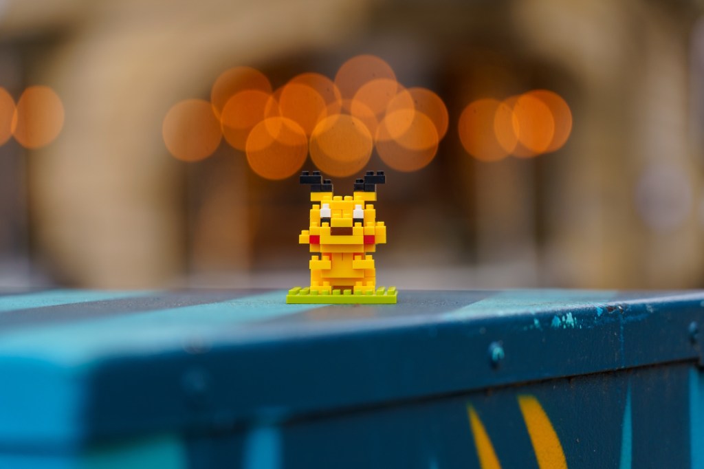 Pikachu Lego figure with blurred lights in background