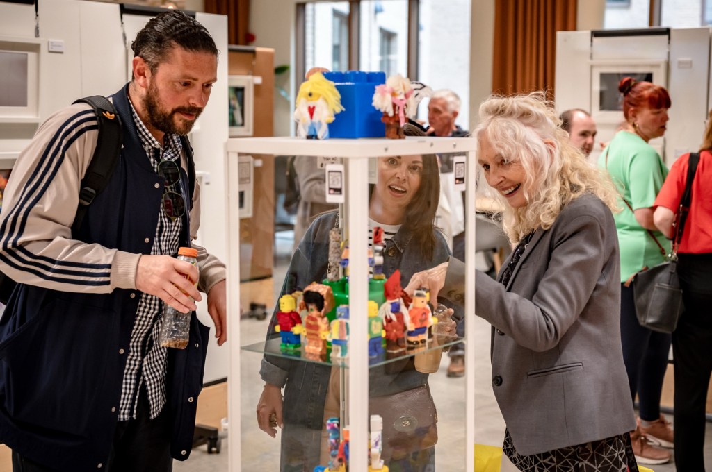 People admiring the customised Lego figures