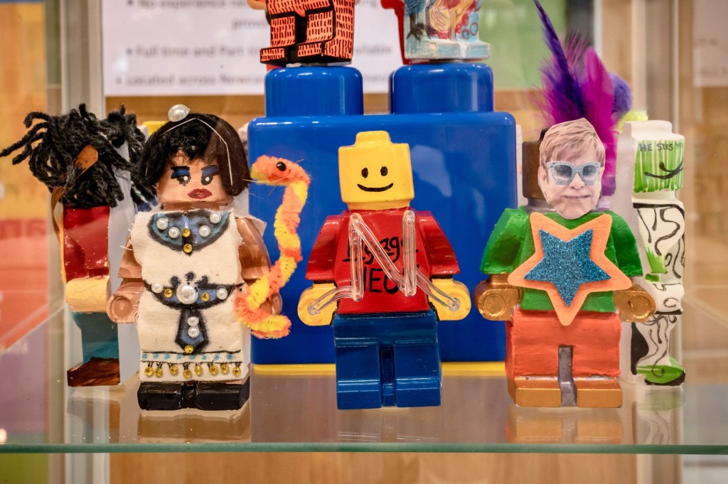 A group of Lego figures one featuring Cleopatra and one of Elton John